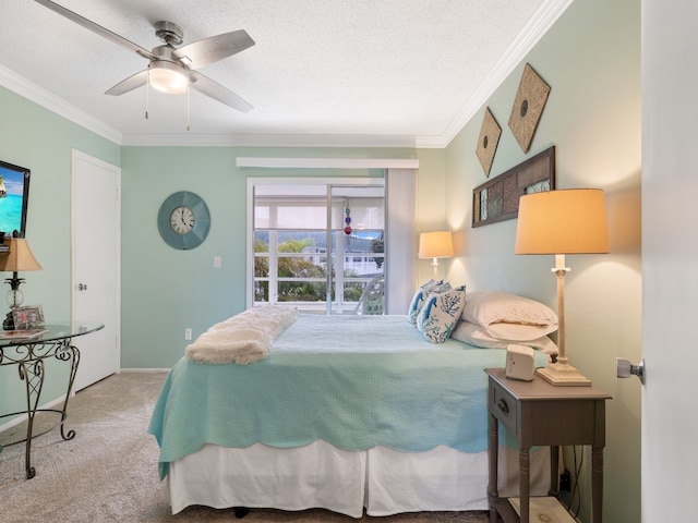 carpeted bedroom featuring ornamental molding, a textured ceiling, and ceiling fan