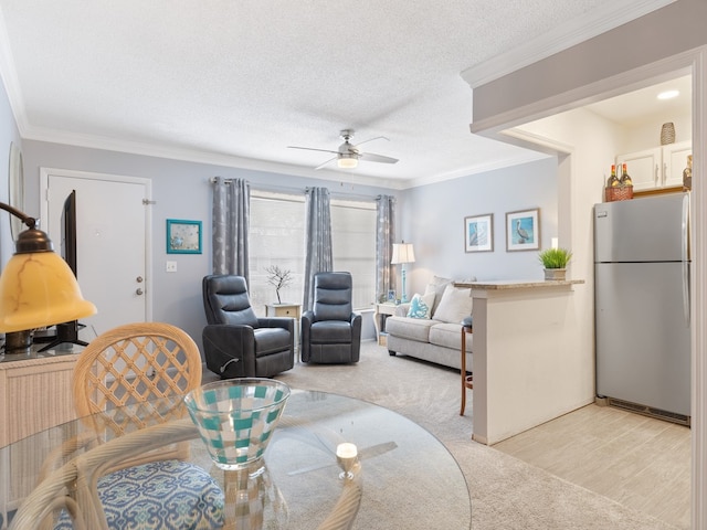 carpeted living room featuring crown molding, a textured ceiling, and ceiling fan