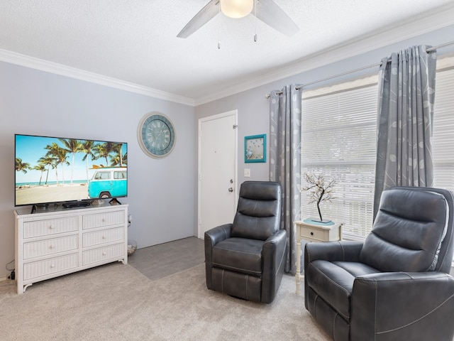 living area featuring a textured ceiling, light colored carpet, ceiling fan, and crown molding