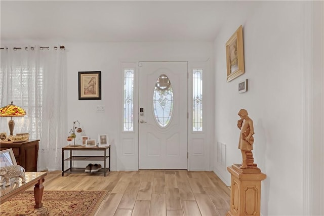 foyer entrance with light wood-type flooring