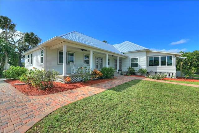 single story home with a porch and a front lawn