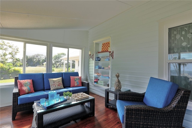 sunroom / solarium featuring vaulted ceiling