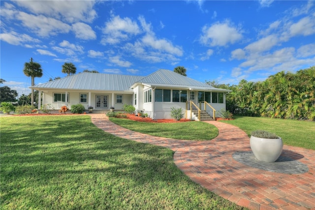 single story home with a sunroom and a front yard