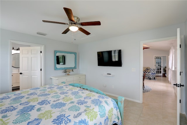 tiled bedroom featuring ensuite bath and ceiling fan