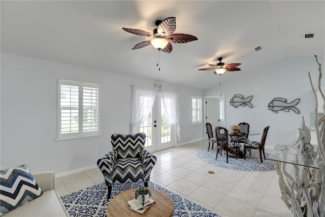 tiled living room featuring a wealth of natural light, french doors, ceiling fan, and vaulted ceiling