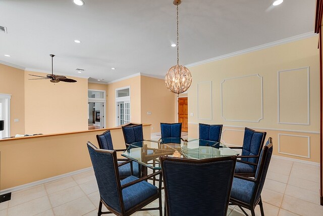 tiled dining space featuring ceiling fan with notable chandelier and crown molding