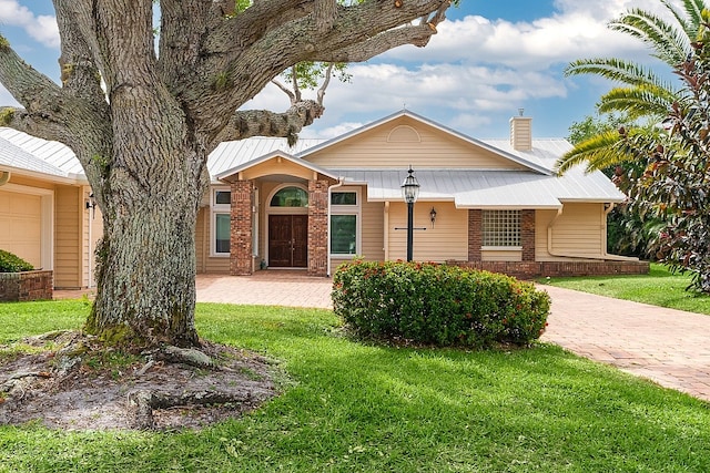 view of front of home with a front lawn and a garage