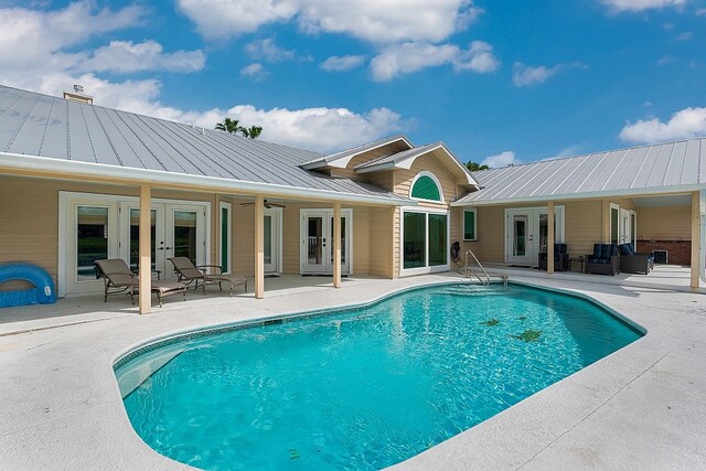 view of pool with ceiling fan, french doors, and a patio area