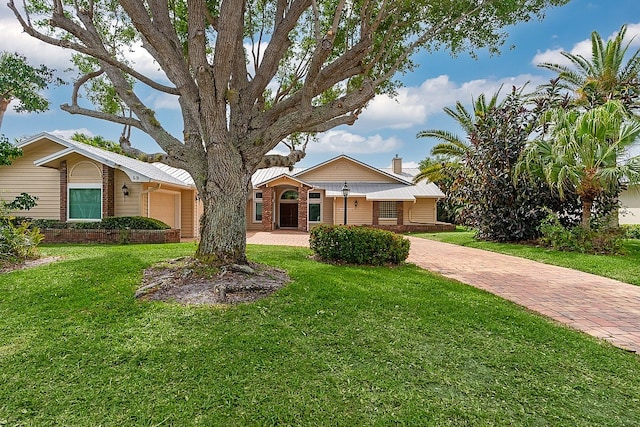 view of front facade with a front lawn and a garage