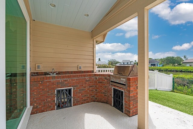 view of patio with an outdoor kitchen and sink