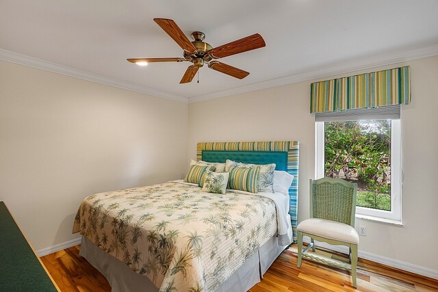 bedroom featuring ornamental molding, hardwood / wood-style floors, and ceiling fan