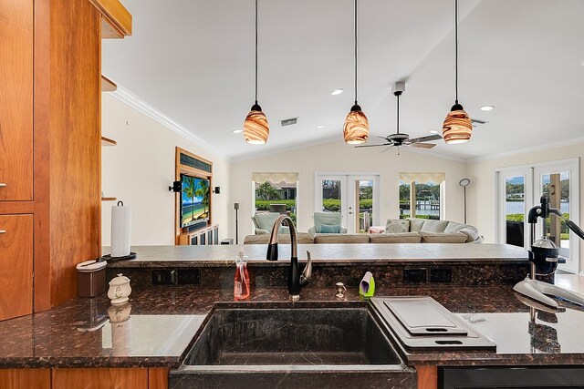 kitchen featuring hanging light fixtures, sink, ornamental molding, and french doors