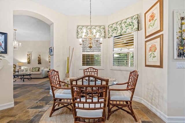 dining room with a textured ceiling and a notable chandelier