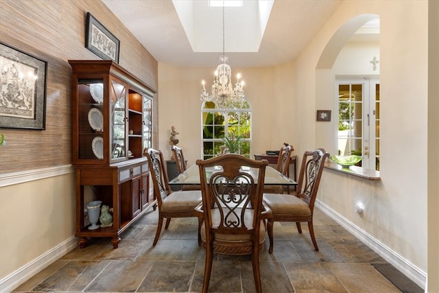 dining space with a wealth of natural light and an inviting chandelier