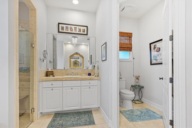 bathroom featuring vanity, tile patterned flooring, toilet, and an enclosed shower