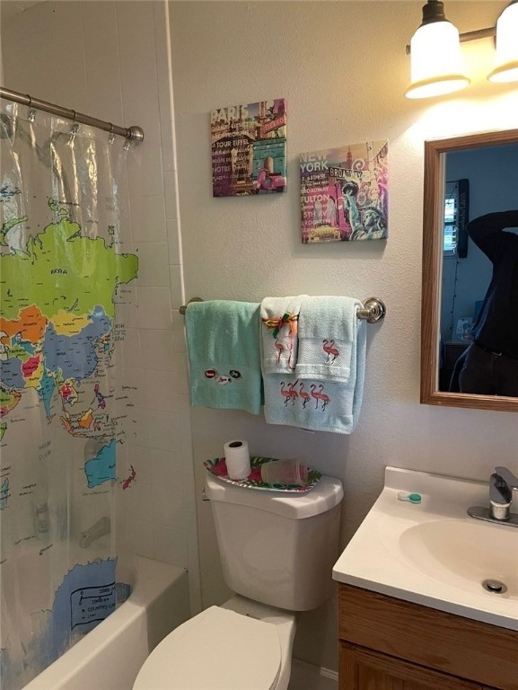 full bathroom with vanity, toilet, and shower / bath combo with shower curtain