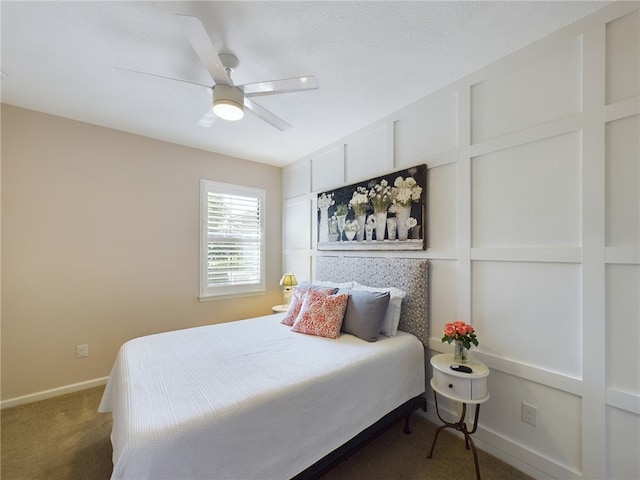 bedroom with ceiling fan and dark colored carpet