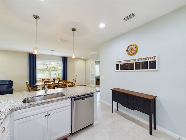 kitchen featuring dishwasher, white cabinets, sink, light stone countertops, and pendant lighting