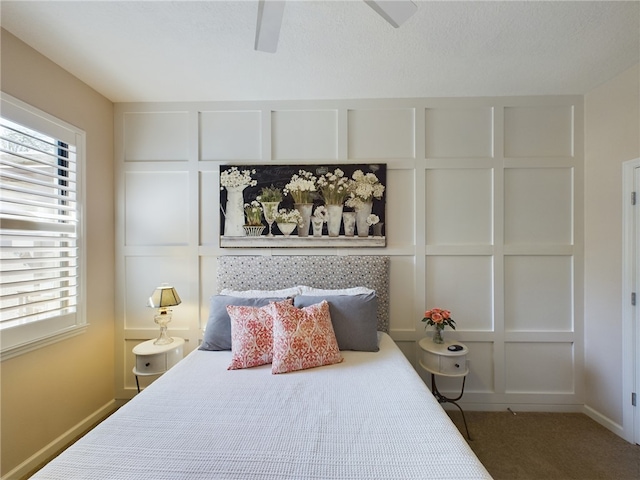 bedroom featuring a textured ceiling, ceiling fan, and carpet floors