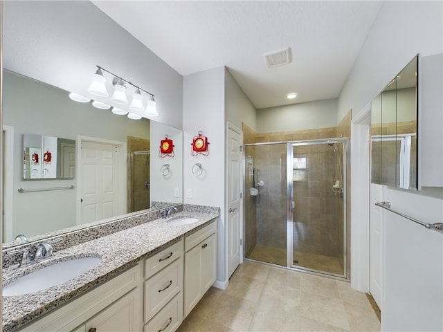 bathroom featuring walk in shower, vanity, and tile patterned floors