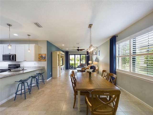 dining area with ceiling fan, plenty of natural light, and light tile patterned floors