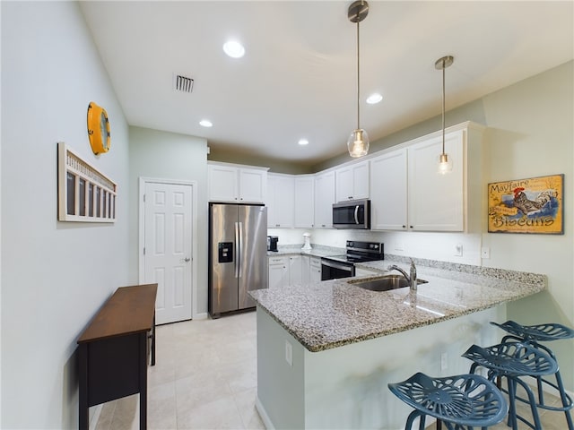 kitchen featuring stainless steel appliances, white cabinets, kitchen peninsula, hanging light fixtures, and sink