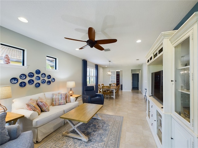 tiled living room featuring ceiling fan