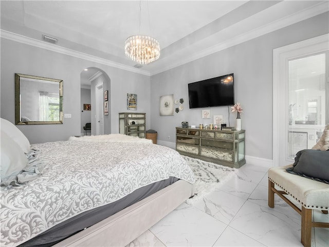 bedroom with ornamental molding, a notable chandelier, and connected bathroom