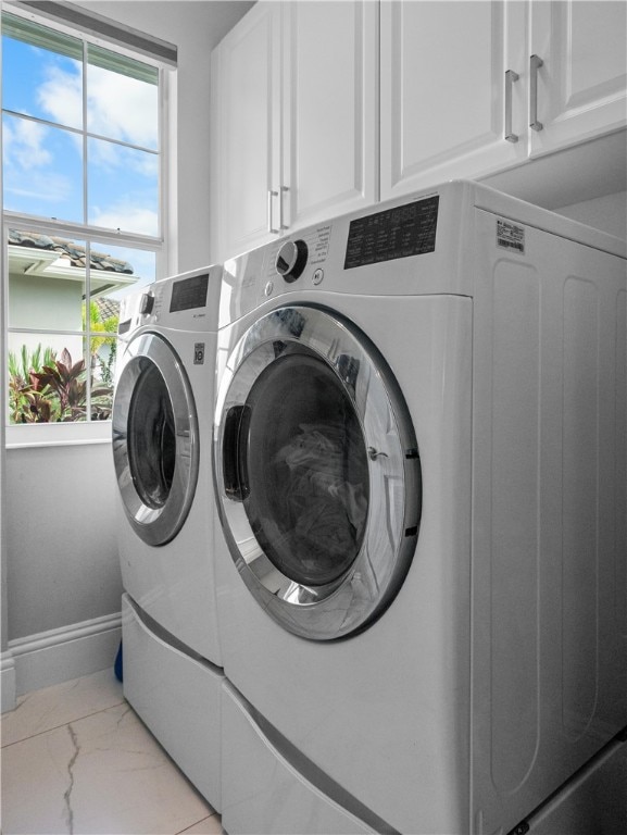 laundry area with cabinets and separate washer and dryer