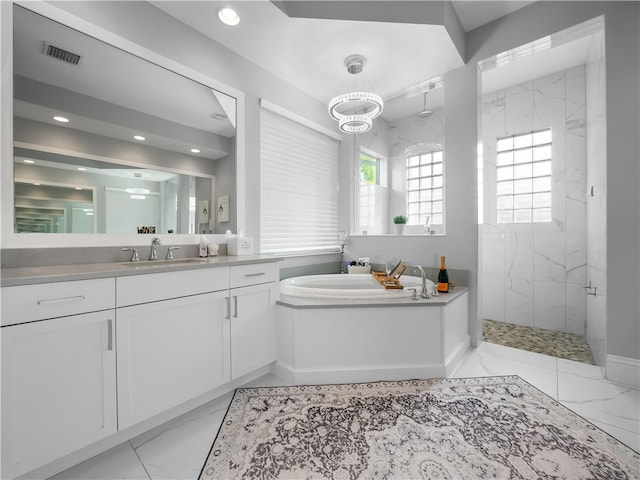 bathroom with shower with separate bathtub and vanity