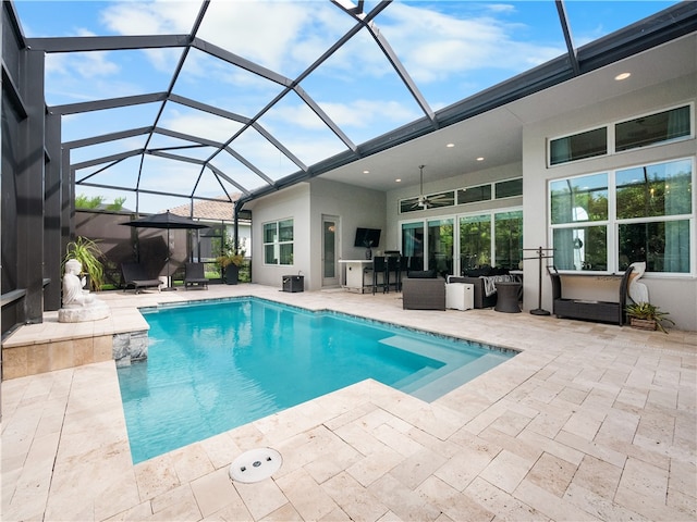 view of swimming pool with a patio, ceiling fan, and glass enclosure