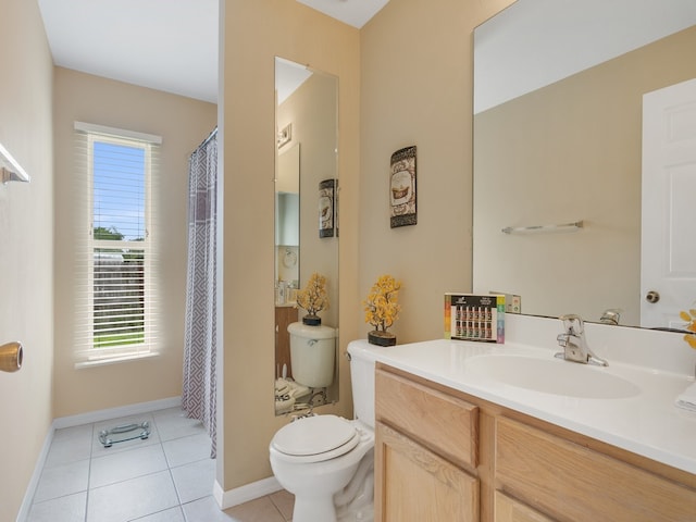 bathroom featuring vanity, tile patterned floors, and toilet