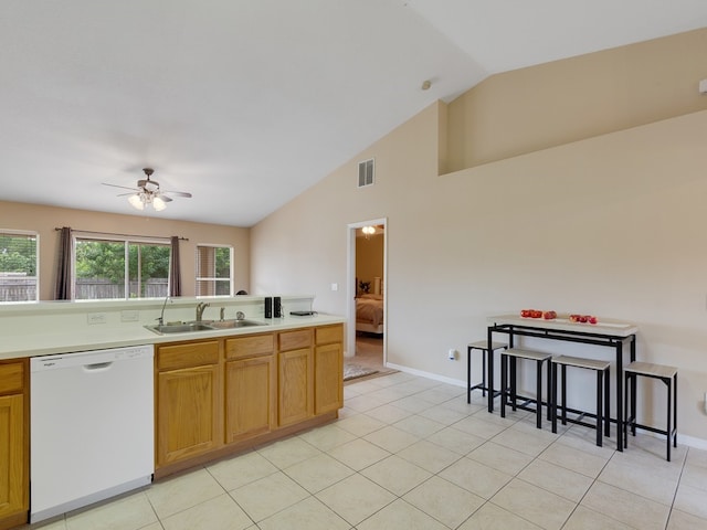 kitchen with light tile patterned flooring, lofted ceiling, sink, ceiling fan, and white dishwasher