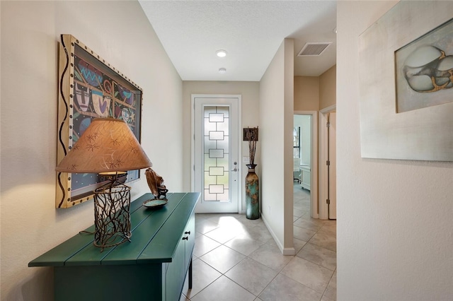 doorway featuring light tile patterned floors