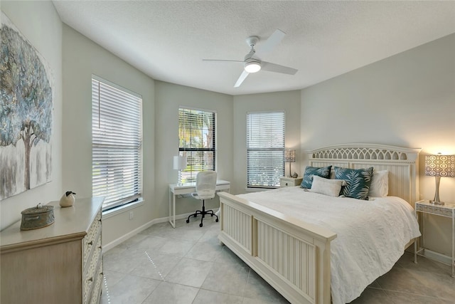 tiled bedroom featuring a textured ceiling and ceiling fan