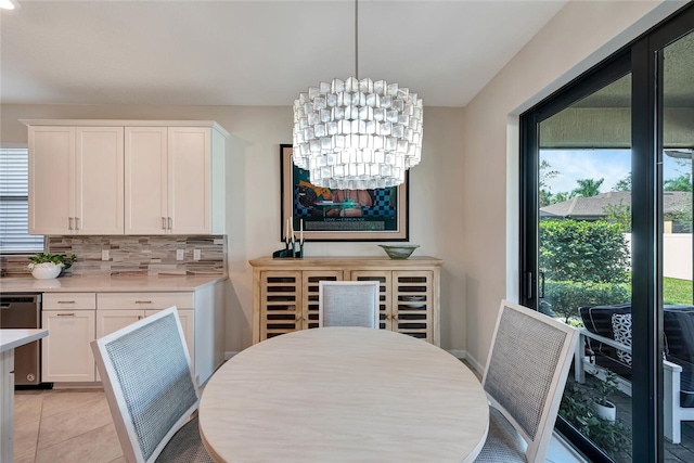 tiled dining room featuring an inviting chandelier