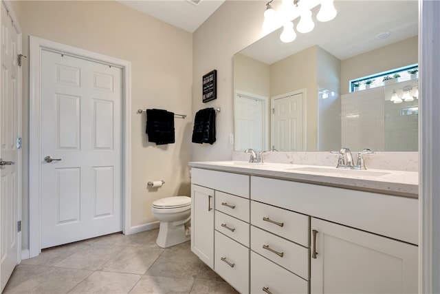 bathroom featuring a shower, tile patterned flooring, vanity, and toilet