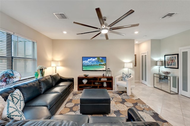 living room with light tile patterned floors and ceiling fan