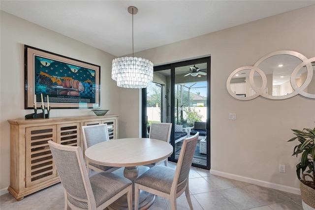 dining area with light tile patterned floors and ceiling fan with notable chandelier