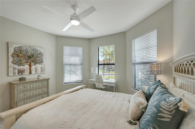 bedroom with a textured ceiling and ceiling fan