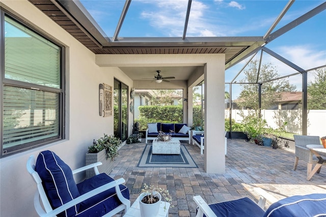 view of patio / terrace with ceiling fan, a lanai, and an outdoor hangout area