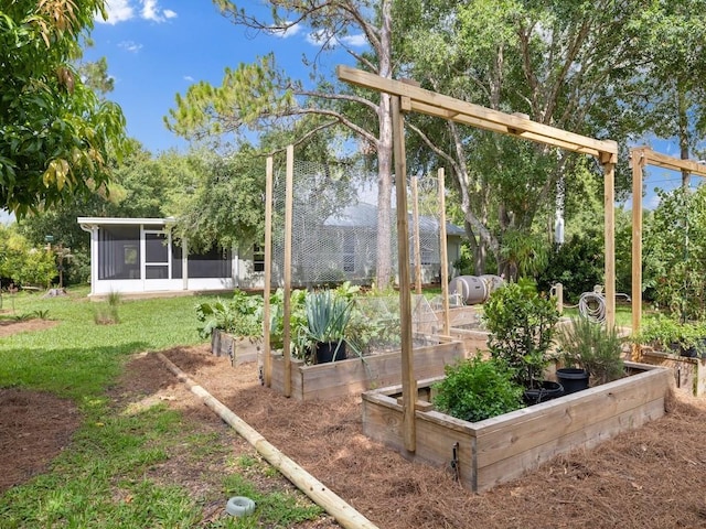 view of green lawn with a garden and a sunroom