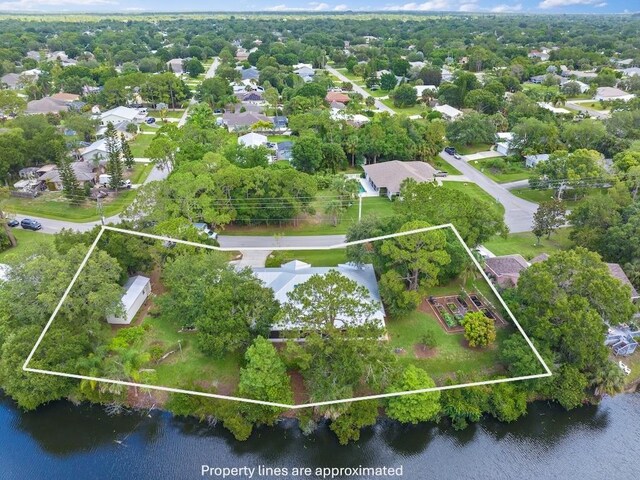 aerial view of residential area featuring property parcel outlined and a large body of water