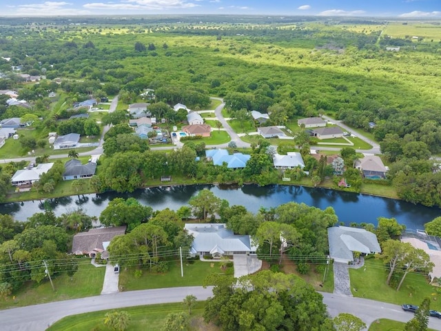 aerial view of a nearby body of water and a heavily wooded area