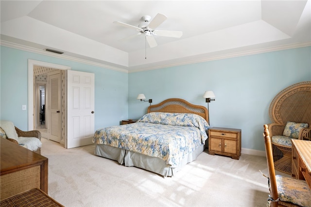 carpeted bedroom with crown molding, ceiling fan, and a raised ceiling