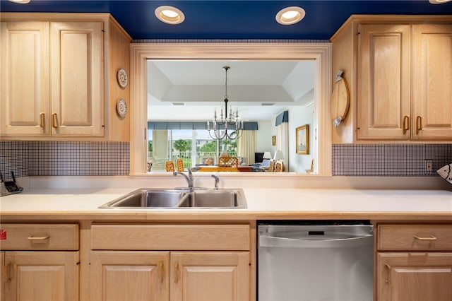 kitchen with sink, dishwasher, light brown cabinets, and decorative light fixtures