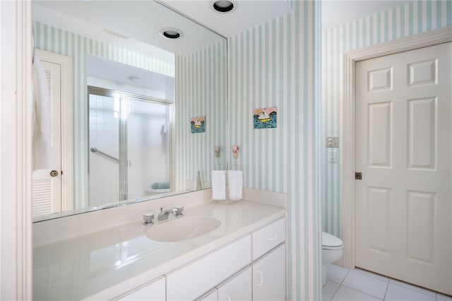 bathroom with walk in shower, toilet, tile patterned floors, and vanity