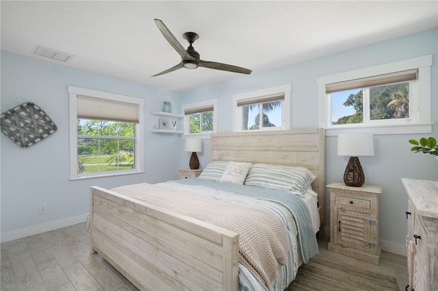 bedroom with ceiling fan and light hardwood / wood-style floors