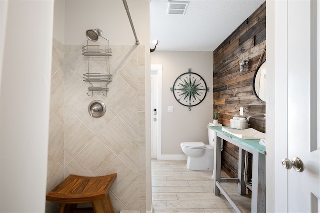 bathroom featuring toilet, vanity, wood-type flooring, and walk in shower