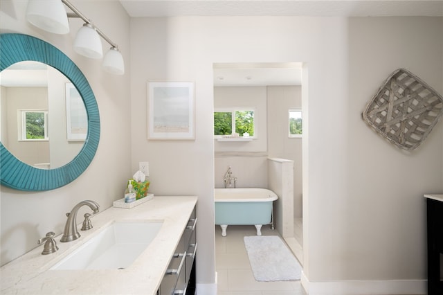 bathroom with a tub to relax in, tile patterned flooring, and vanity